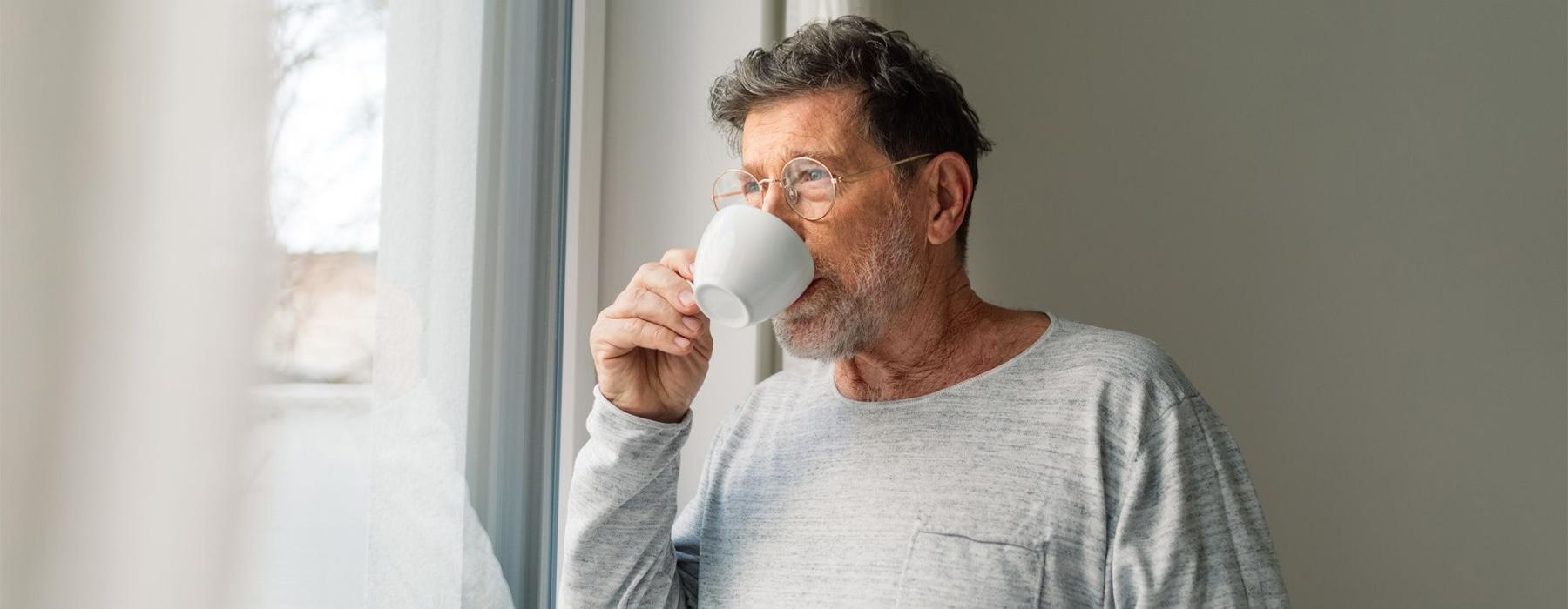 a man drinking from a cup